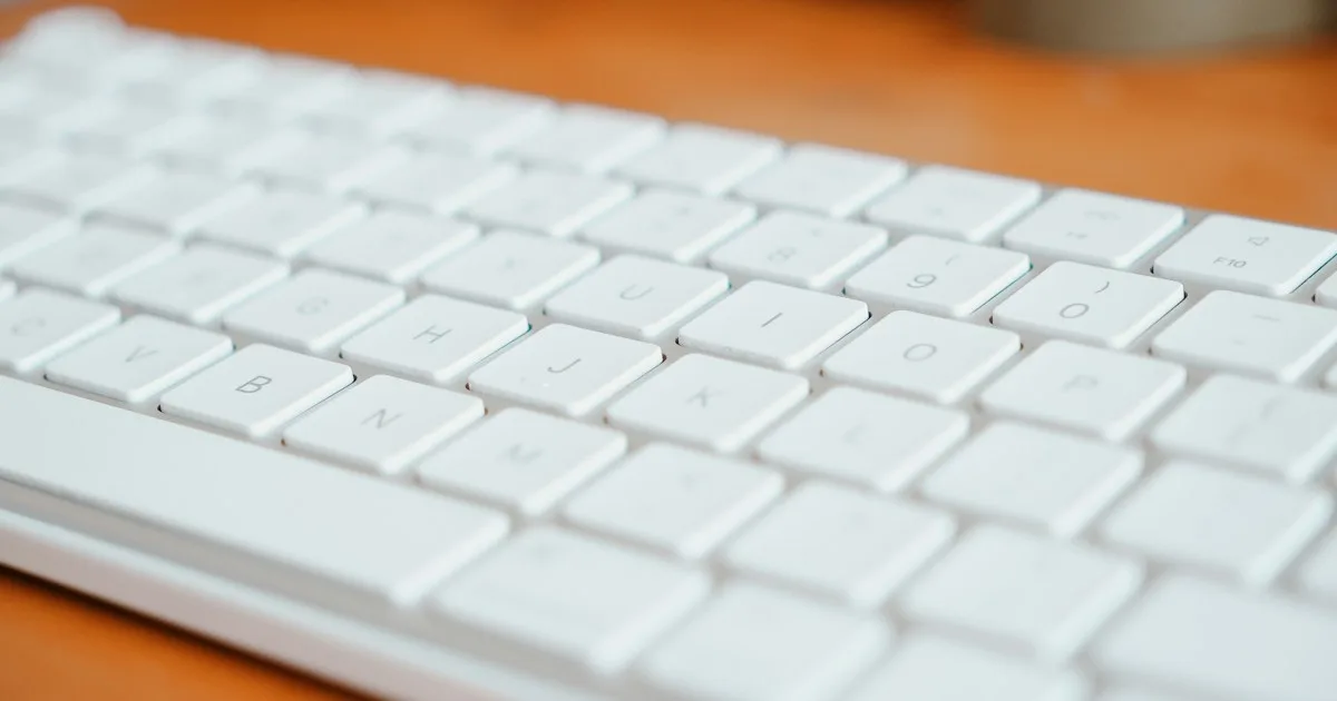 Low-profile keyboard on a wooden desk with space under the rear edge - KeyRiser